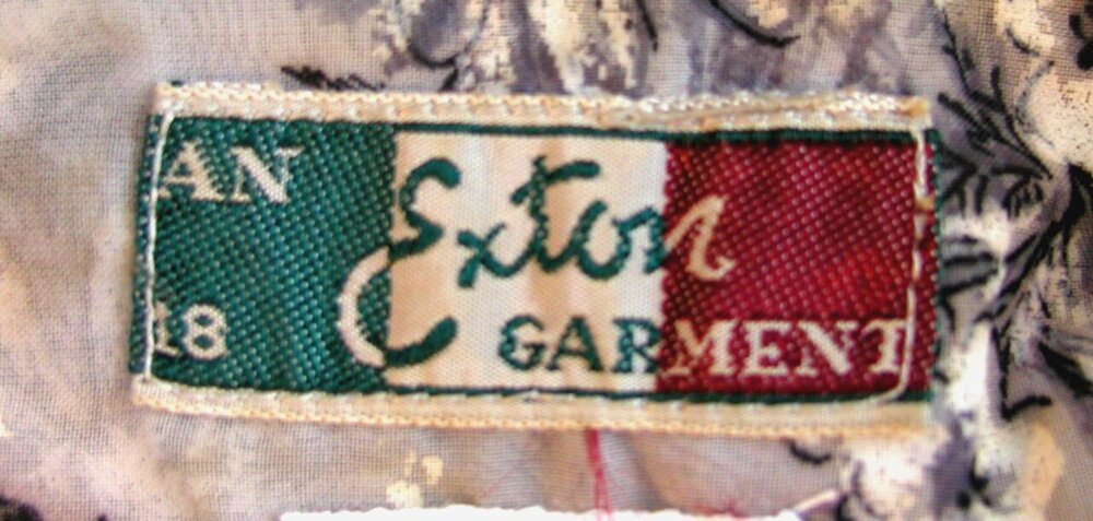 Woven green, white and red maker's label reading Exton Garment, with a size 18 marking